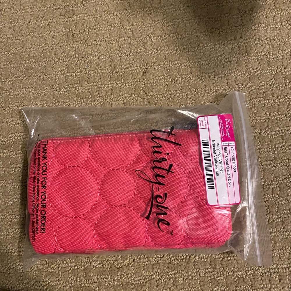 Brand New Thirty-One Vary You Wristlet in coral pink.  Comes in package.